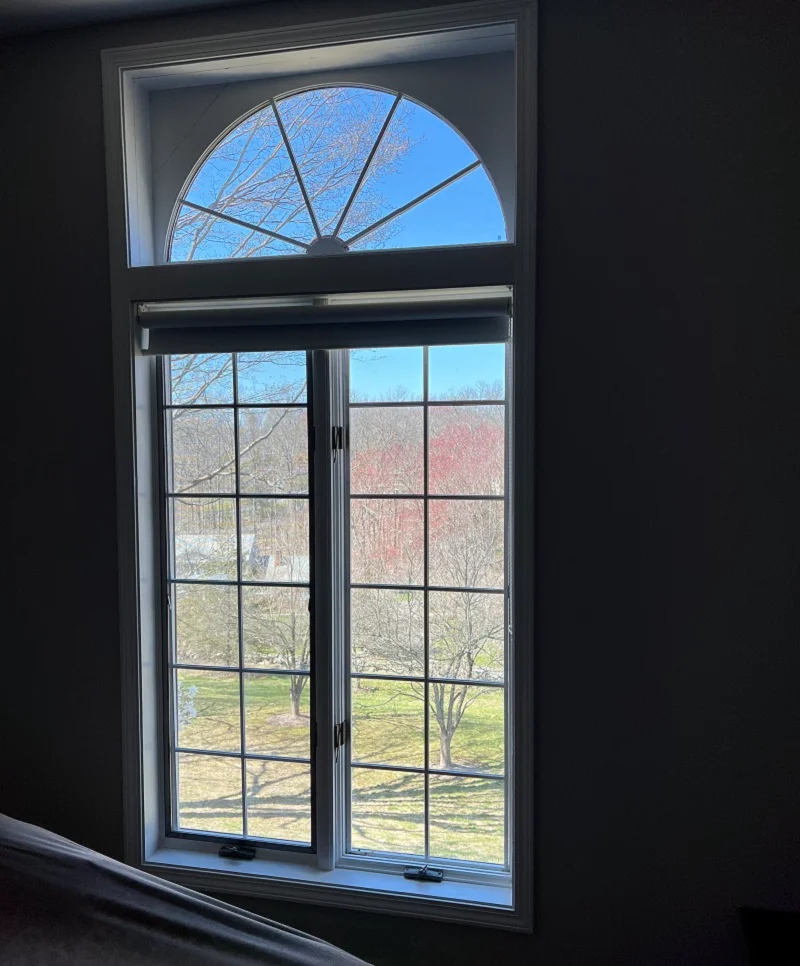 Custom arched window over a casement 